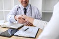 Professional Male doctor in white coat shaking hand with female patient after successful recommend treatment methods, Medicine and Royalty Free Stock Photo