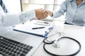 Professional Male doctor in white coat shaking hand with female patient after successful recommend treatment methods, Medicine and Royalty Free Stock Photo