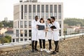 Professional male and female multiracial doctors examining patient's tomography