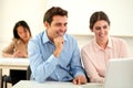 Professional male and female working on laptop Royalty Free Stock Photo