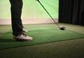 Professional male golfer playing golf indoors in golf simulator closeup Royalty Free Stock Photo