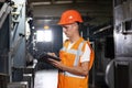 Professional Male Heavy Industry Engineer Wearing Safety Uniform and Using Tablet Computer. Industrial Specialist