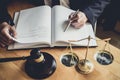 Professional Male lawyer or judge working with contract papers, documents and gavel and Scales of justice on table in courtroom, Royalty Free Stock Photo