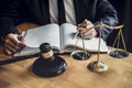 Professional Male lawyer or judge working with contract papers, documents and gavel and Scales of justice on table in courtroom, Royalty Free Stock Photo