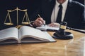 Professional Male lawyer or judge working with contract papers, documents and gavel and Scales of justice on table in courtroom, Royalty Free Stock Photo