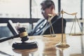 Professional Male lawyer or judge working with contract papers, documents and gavel and Scales of justice on table in courtroom, Royalty Free Stock Photo