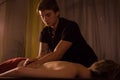 Professional male masseur doing massage for female client at spa salon Royalty Free Stock Photo