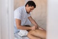 Professional male masseur therapist performs therapeutic body massage for young woman