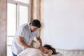 Professional male masseuse and his patient in a spa, Therapist performing massage on a female back. Bright background, general