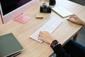 Professional male photographer working at his desk, using computer. cropped image Royalty Free Stock Photo