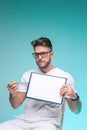 Professional male physician practitioner in glasses pointing on blank space on white sheet. Doctor report, diagnosis Royalty Free Stock Photo