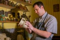 Professional male potter examining jug in pottery workshop Royalty Free Stock Photo