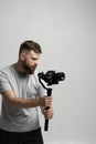 Professional male videographer filmmaker cinematographer dop shooting video using modern dslr camera on 3-axis gimbal