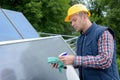 professional male worker cleaning grime from solar panel Royalty Free Stock Photo