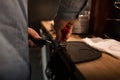 Professional man barista pressing ground coffee using a tamper in a coffee shop. Coffee time. Coffee break. Royalty Free Stock Photo