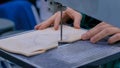 Carpenter using bandsaw tool, cutting piece of wood at workshop - close up Royalty Free Stock Photo