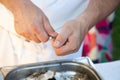 Professional man chef worker opens shucking of oyster