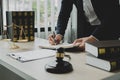 Professional man lawyers work at a law office There are scales, Scales of justice, judges gavel, and litigation documents.