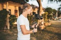 Professional man videographer with gimball video slr