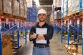 Professional Man Worker wearing hard hat checks stock and inventory with Laptop Computer. Looking at camera Royalty Free Stock Photo