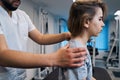 Professional manual therapist treats little girls neck on massage bed closeup. Osteopath-masseur Royalty Free Stock Photo