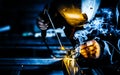 Professional mask protected welder man working on metal welding and sparks metal Royalty Free Stock Photo