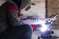 Professional mask protected welder man working on metal welding and sparks metal. stock photo Royalty Free Stock Photo