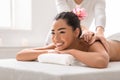 Professional massage advertisement concept. Young woman getting classical body therapy with organic oils at spa Royalty Free Stock Photo