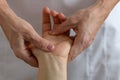 Professional massage therapist working on a woman hand and foot Royalty Free Stock Photo