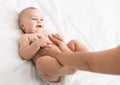 Professional masseur doing massage to newborn baby Royalty Free Stock Photo