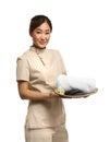 Professional masseuse in spa uniform holding tray with towel and rocks Royalty Free Stock Photo