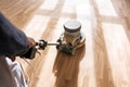 A professional master cleans the floor with a polishing machine Royalty Free Stock Photo