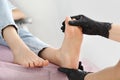 Professional master making foot massage to client in beauty salon, closeup. Preparation for pedicure procedure Royalty Free Stock Photo