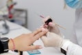 Professional master manicurist applying nail polish in beauty salon Royalty Free Stock Photo