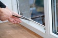 Professional master at repair and installation of windows, changes rubber seal gasket in pvc windows