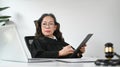 Professional mature female lawyer signing document and using laptop at her workplace. Lawyer, justice and law ,attorney Royalty Free Stock Photo