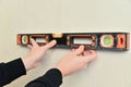 Worker hold in hand spirit level instrument Royalty Free Stock Photo