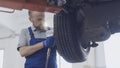 Mechanic doing a wheel replacement using a pneumatic wrench