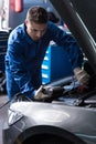 Professional mechanic examining engine Royalty Free Stock Photo