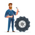 Professional mechanic holding spanner and screwdriver with big tire Royalty Free Stock Photo