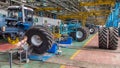 Professional mechanic install tire on wheel in repair service on tractor factory timelapse.