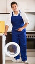 Professional mechanic repairing washing machine