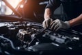 Professional mechanic working on the engine of the car in the garage. Car repair service. Ai generative