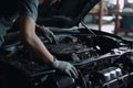 Professional mechanic working on the engine of the car in the garage. Car repair service. Ai generative