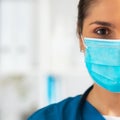 Professional medical doctor working in hospital office, Portrait of young and attractive female physician in protective Royalty Free Stock Photo