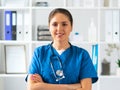 Professional medical doctor working in hospital office, Portrait of young and attractive female physician in protective Royalty Free Stock Photo