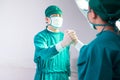 Professional medical doctors performing surgery. Doctors team soul brother handshake, thumb clasp handshake or homie handshake, Royalty Free Stock Photo