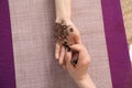 Professional mehndi master making henna tattoo at table, top view Royalty Free Stock Photo