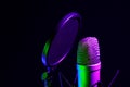 Professional microphone against black background in studio Royalty Free Stock Photo