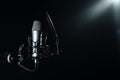 Professional microphone against black background in studio Royalty Free Stock Photo